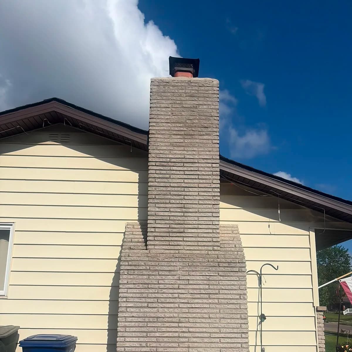 Tall exterior chimney after masonry restoration