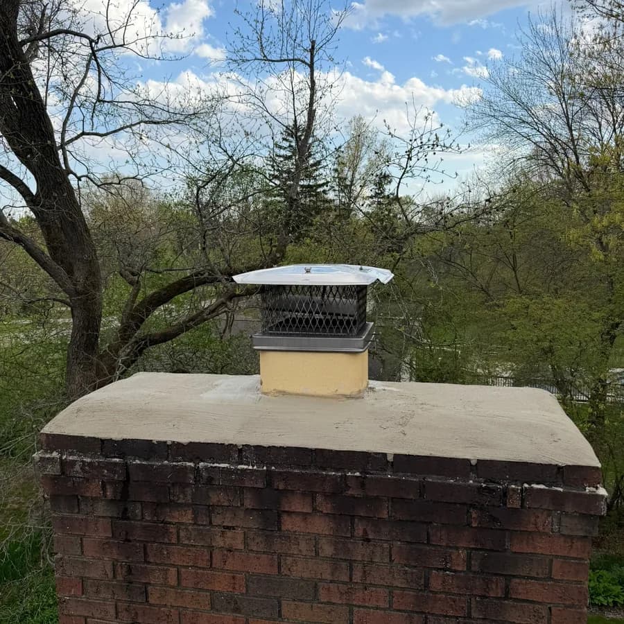 Rebuilt chimney crown with a fitted screened cap