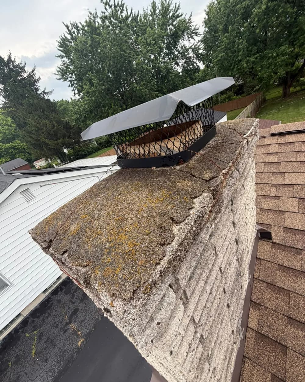 Cracked and weathered chimney crown before repair